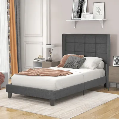 A bedroom scene with a bed, nightstand, and curtains.