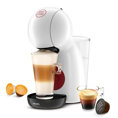 A white Nescafé Dolce Gusto coffee machine is shown with a glass of latte, espresso, and coffee capsules.