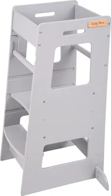 A gray wooden learning tower for children.