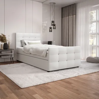 A white boxspring bed in a modern bedroom setting.
