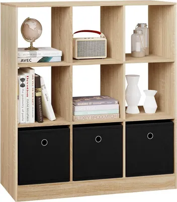 A light wood cube shelf unit filled with books, decorative items, and storage boxes.