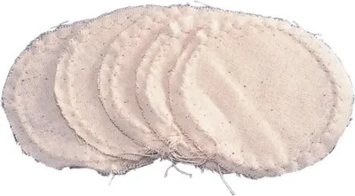 A stack of oval-shaped, off-white fabric items with frayed edges, lying on a white background.