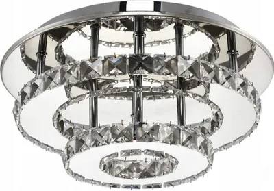 A close-up, studio shot of a modern, multi-tiered crystal ceiling light fixture.