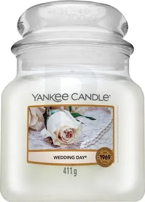 A Yankee Candle jar with a label showing a white rose and pearls.