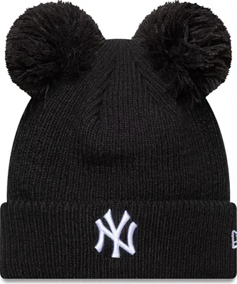 A black New York Yankees beanie with two pom-poms on top and the team logo embroidered on the front.