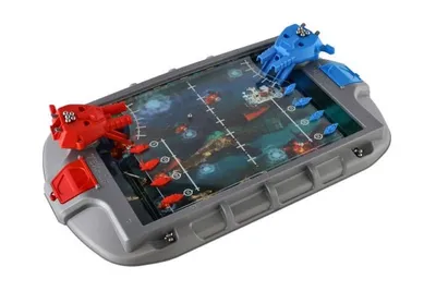 A tabletop board game with two player stations, each featuring a red or blue ship and game pieces on a grid representing a battlefield.