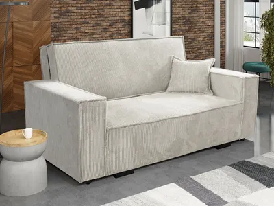 A living room scene featuring a sofa, side table, and rug.