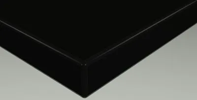 A close-up view of the corner of a black panel, likely a piece of furniture or a decorative element.