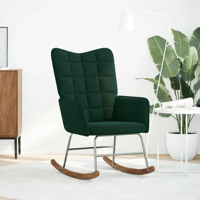 A dark green velvet rocking chair in a minimalist room setting.