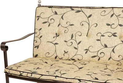 A close-up view of a bench cushion with a floral vine pattern.