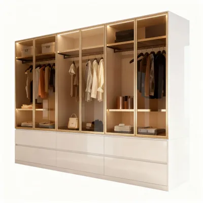 A modern, well-lit wardrobe with glass doors and gold-colored frames, showcasing organized clothing and accessories.