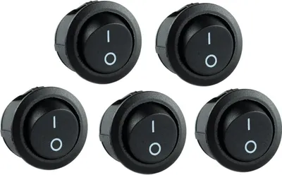 A group of five black, round rocker switches with a white 'I' and 'O' symbol indicating on and off positions.