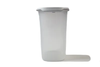 A clear studio shot of a translucent gray Tupperware storage container with a white lid, placed on a white background.