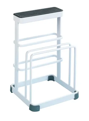 A white cutting board and knife holder stand.