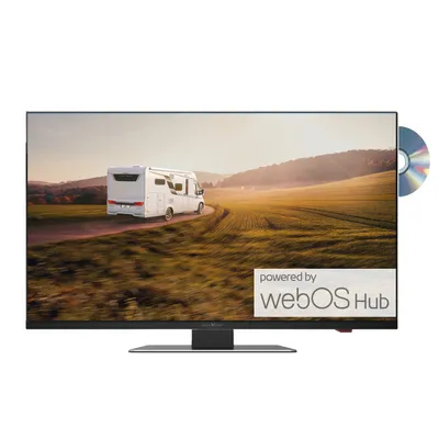 A flat-screen TV with a scenic image displayed on its screen, showing a camper van on a road in a field.