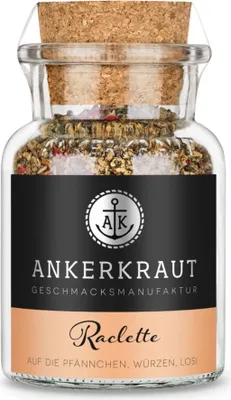 A glass jar of spice blend with a cork stopper, on a white background.