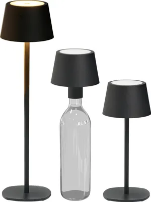 Three black LED table lamps of different heights, one of which is placed on a clear glass bottle.