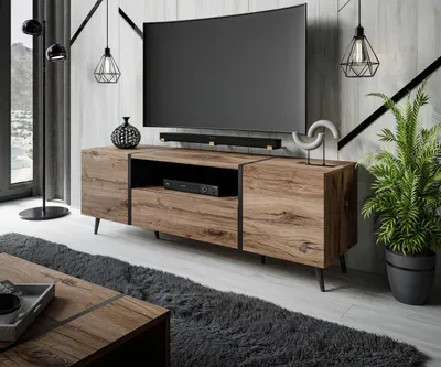 A modern living room with a TV stand, TV, and decor.