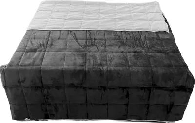 A weighted blanket is shown on a bed.