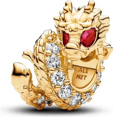 A close-up studio shot of a gold dragon charm with red eyes and clear stones.