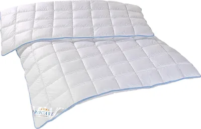 A white quilted comforter with blue trim is laid out on a white background.