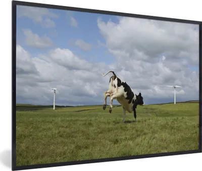 Produktbild von MuchoWow® MuchoWow® Gerahmtes Poster Kuh - Windmühle - Wolken 90x60 cm - Poster mit zchwarzem Bilderrahmen - Fotorahmen - Foto-Plakat