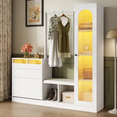 A well-lit entryway or hallway featuring a white storage unit with hanging clothes, a bench, and a glass-doored cabinet.