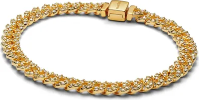 A close-up studio shot of a gold bracelet with small diamonds.