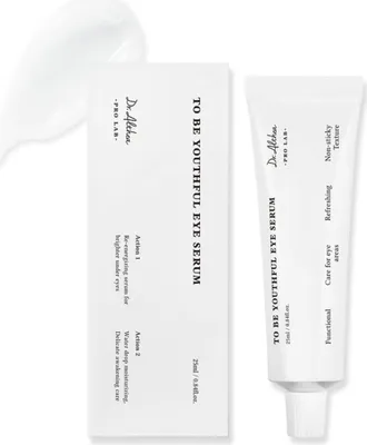 A product shot of an eye serum tube and its packaging, with a dollop of the serum beside it.