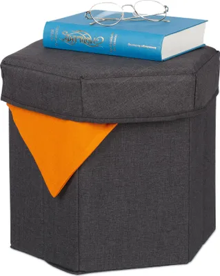 A hexagonal storage ottoman with a book and glasses on top, set against a white background.