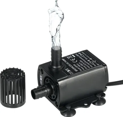 A black mini brushless DC water pump with water spraying from its outlet, shown with a separate filter attachment.