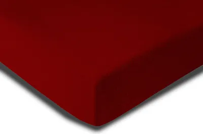 A close-up view of a bordeaux-colored fleece fabric, likely a fitted sheet, with a shadow cast on a white background.