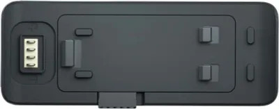 A top-down view of a black battery pack for a camera.