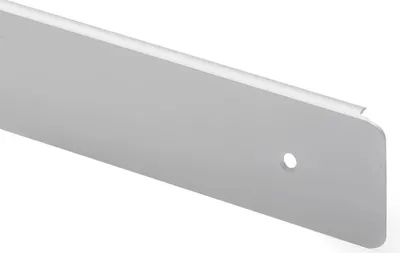 A close-up, angled view of a single, light gray, metallic-looking object with a hole drilled through it.
