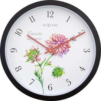 A wall clock with a floral design.