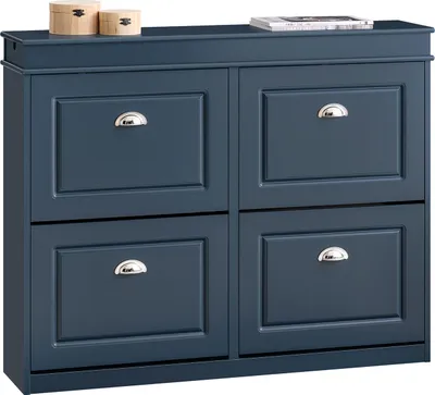 A blue shoe cabinet with four flip-down doors and silver handles, placed on a white background. Two small wooden boxes and a book are on top of the cabinet.