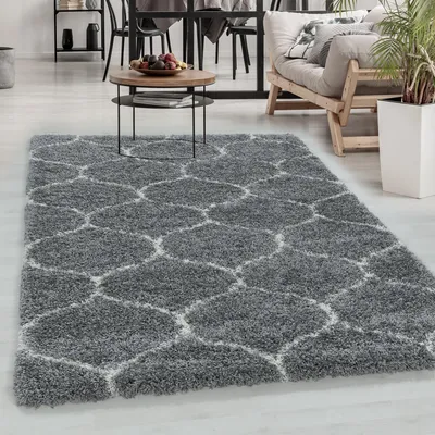 A living room scene with a rug, coffee table, and sofa.