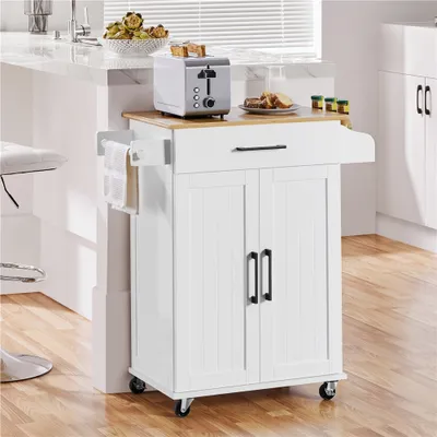 A white kitchen cart with a wooden top is shown in a kitchen setting next to a counter and a stool.
