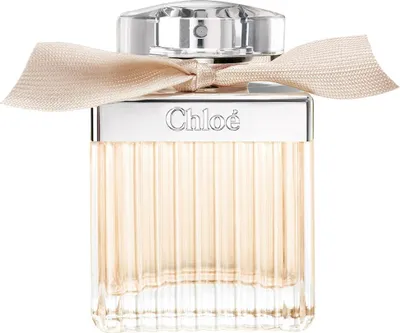A Chloé Eau de Parfum bottle with a ribbon tied around the neck.