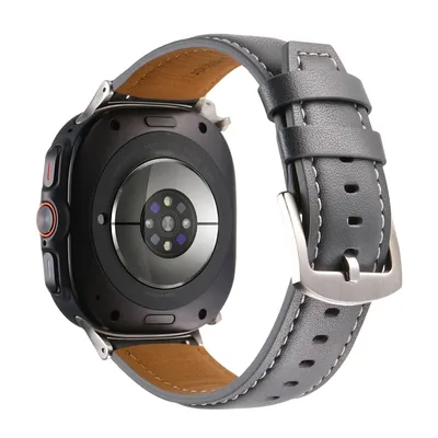 The back of a smartwatch with a leather strap.