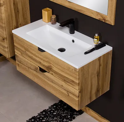 A bathroom vanity with a sink and faucet, set against a dark wall.