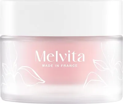 A jar of Melvita cream with floral illustrations.