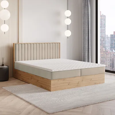 A bedroom scene with a bed, headboard, and a window overlooking a city.