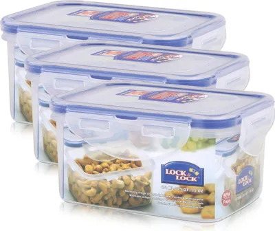 Three clear plastic food storage containers with blue lids are stacked diagonally.