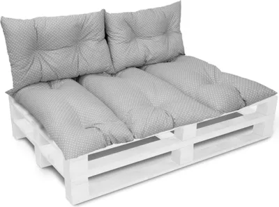 A white wooden pallet sofa with gray patterned cushions.