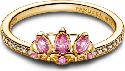 A close-up studio shot of a gold Pandora ring with pink gemstones and small white stones.