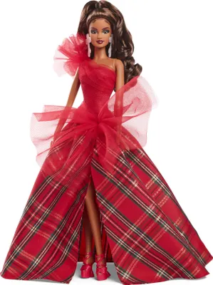 A Barbie doll wearing a red plaid gown.