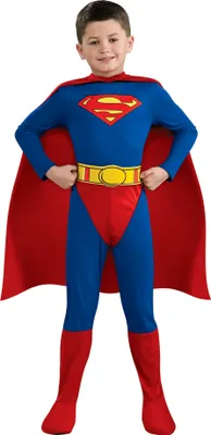 A young boy wearing a Superman costume.