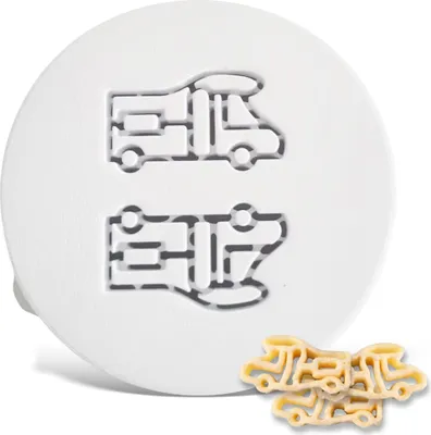 A white round cookie cutter with two RV imprints, and a pile of RV-shaped pasta below.