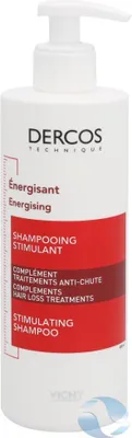 A white bottle of Vichy Dercos shampoo with red and white labeling.